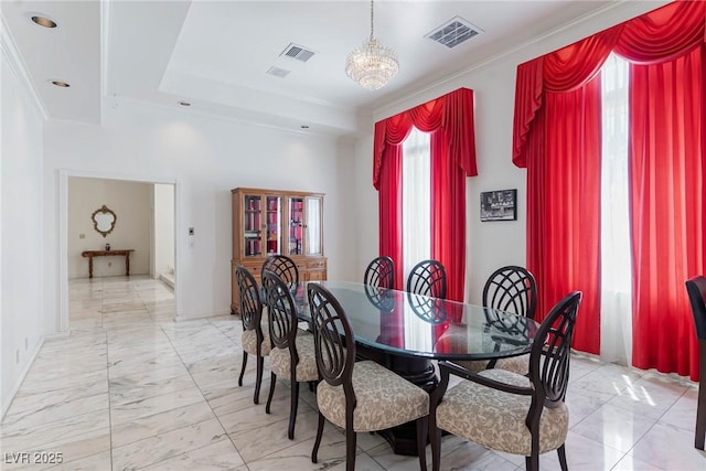 dining room featuring a notable chandelier, visible vents, ornamental molding, and marble finish floor