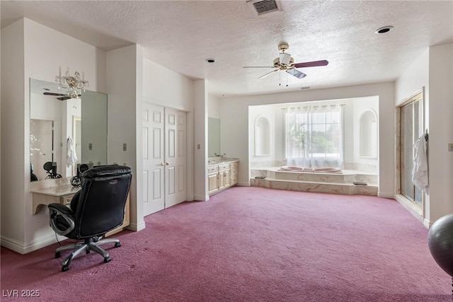carpeted office featuring baseboards, ceiling fan, a textured ceiling, and visible vents