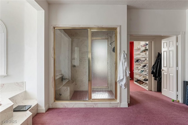 full bathroom featuring carpet floors, a walk in closet, a bathing tub, and a shower stall