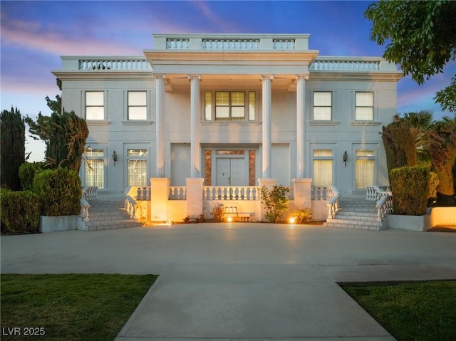 rear view of property with stucco siding and a porch