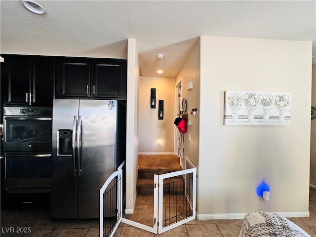 5634 Bishop Flowers St, Las Vegas, NV 89130 - kitchen featuring stainless steel fridge, dark cabinetry, double oven, baseboards, and recessed lighting