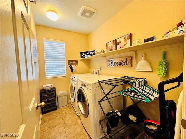5634 Bishop Flowers St, Las Vegas, NV 89130 - laundry room featuring independent washer and dryer, light tile patterned floors, and baseboards