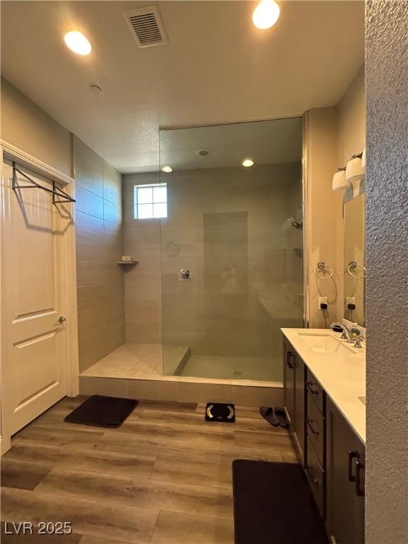 740 Omaggio Pl, Henderson, NV 89011 - full bathroom featuring visible vents, a sink, walk in shower, and wood finished floors