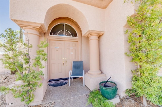 entrance to property featuring stucco siding