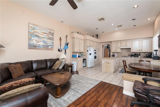 living room with light wood finished floors, a ceiling fan, recessed lighting, and visible vents