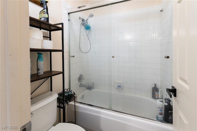 full bath featuring toilet and shower / bath combination with glass door