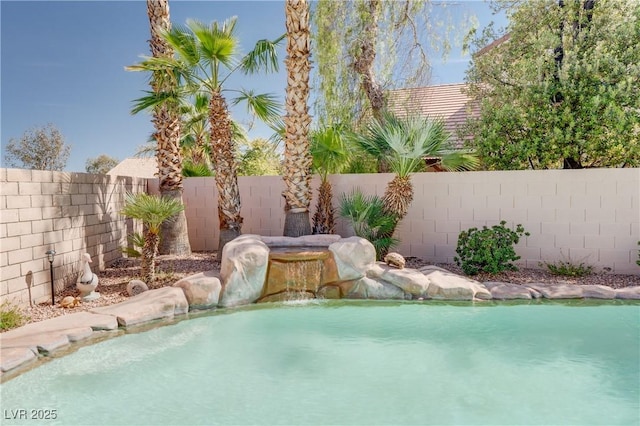 outdoor pool featuring a fenced backyard