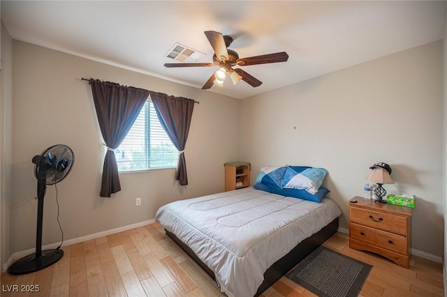 bedroom with baseboards, visible vents, and light wood-style floors