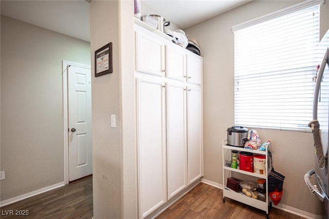recreation room with baseboards and dark wood-style flooring