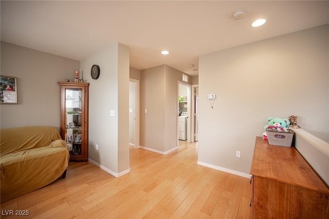interior space featuring recessed lighting, light wood-style flooring, washer / dryer, and baseboards