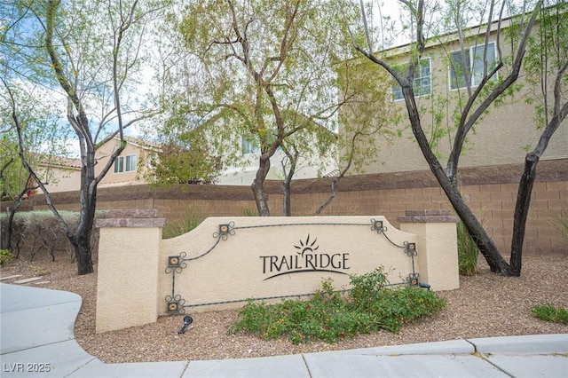 community sign featuring fence