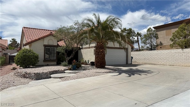 2701 Brookstone Ct, Las Vegas, NV 89117 - mediterranean / spanish-style house with fence, driveway, a tile roof, and stucco siding