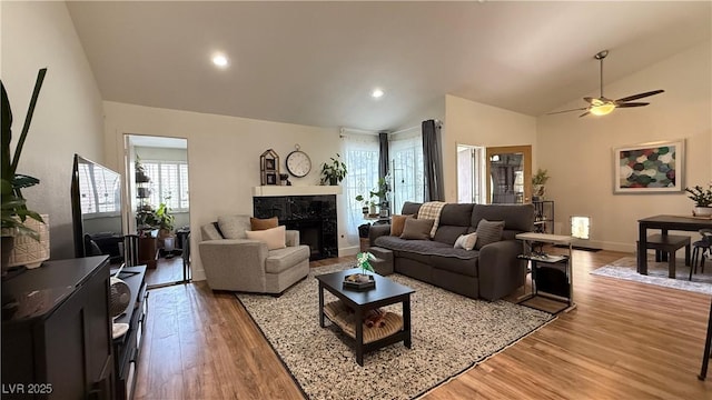 2701 Brookstone Ct, Las Vegas, NV 89117 - living room featuring a healthy amount of sunlight, a high end fireplace, baseboards, and light wood-style floors