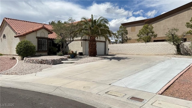 2701 Brookstone Ct, Las Vegas, NV 89117 - exterior space featuring concrete driveway, a tiled roof, fence, and stucco siding