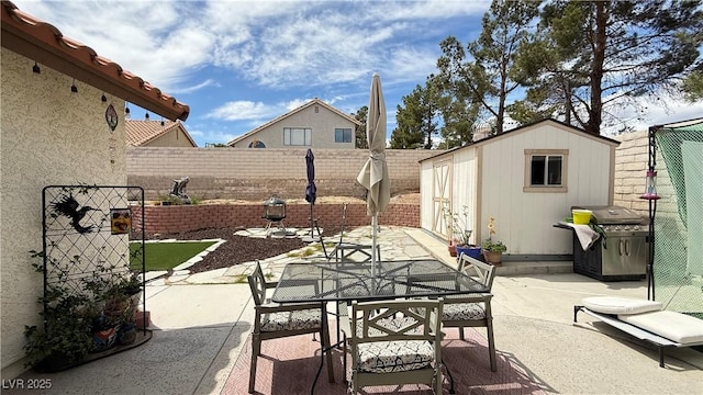 2701 Brookstone Ct, Las Vegas, NV 89117 - view of patio featuring outdoor dining space, a shed, a fenced backyard, an outdoor structure, and a grill