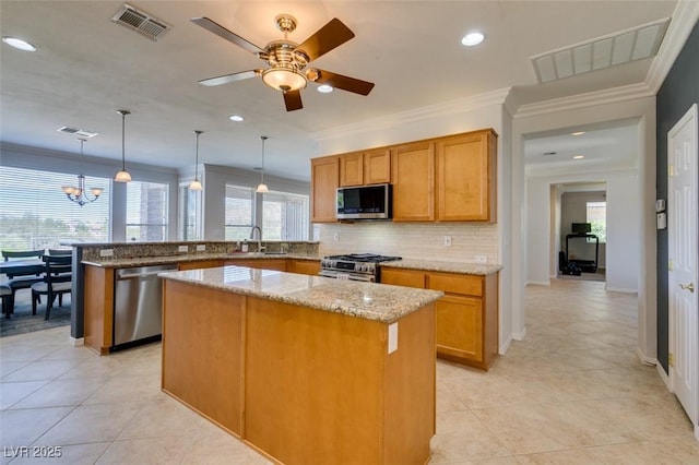 10372 Premia Pl, Las Vegas, NV 89135 - kitchen featuring stainless steel appliances, a peninsula, backsplash, light stone counters, and a kitchen island