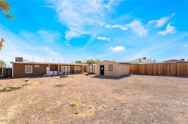 343 Tungsten St, Henderson, NV 89015 - rear view of house featuring a fenced backyard, a storage unit, an outbuilding, and a patio area