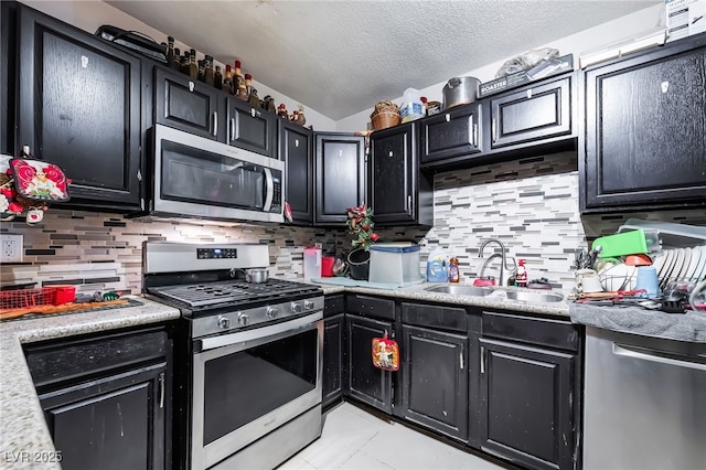 343 Tungsten St, Henderson, NV 89015 - kitchen with a sink, dark cabinetry, and stainless steel appliances