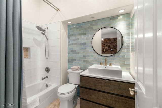 full bathroom with vanity, tub / shower combination, toilet, and tile walls