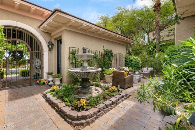 view of patio featuring an outdoor hangout area and a gate
