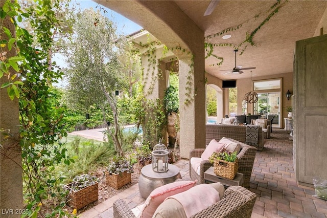 view of patio with a ceiling fan and an outdoor hangout area