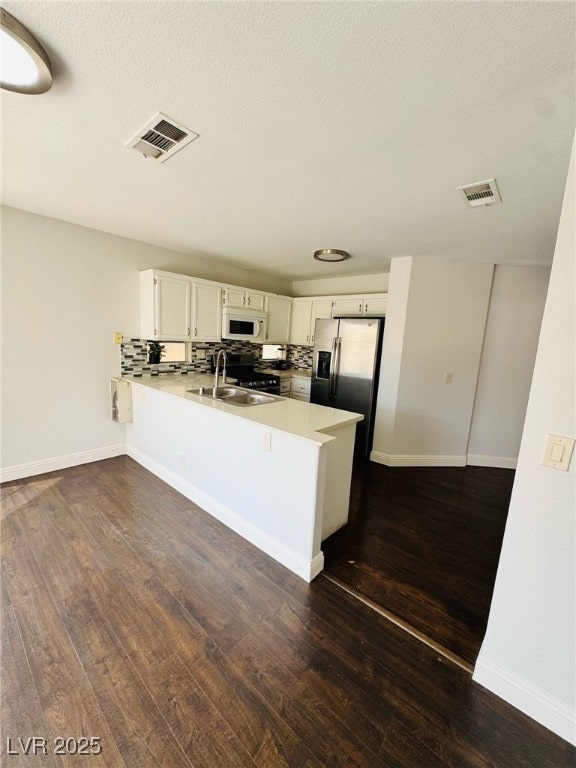 5711 Roundrock Dr, Las Vegas, NV 89142 - kitchen with a sink, white microwave, a peninsula, and visible vents