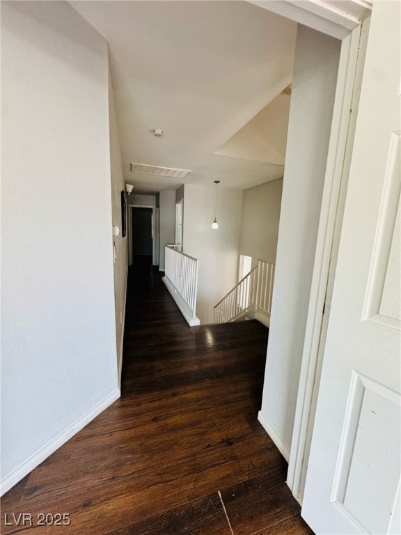 5711 Roundrock Dr, Las Vegas, NV 89142 - corridor featuring baseboards, wood finished floors, and an upstairs landing