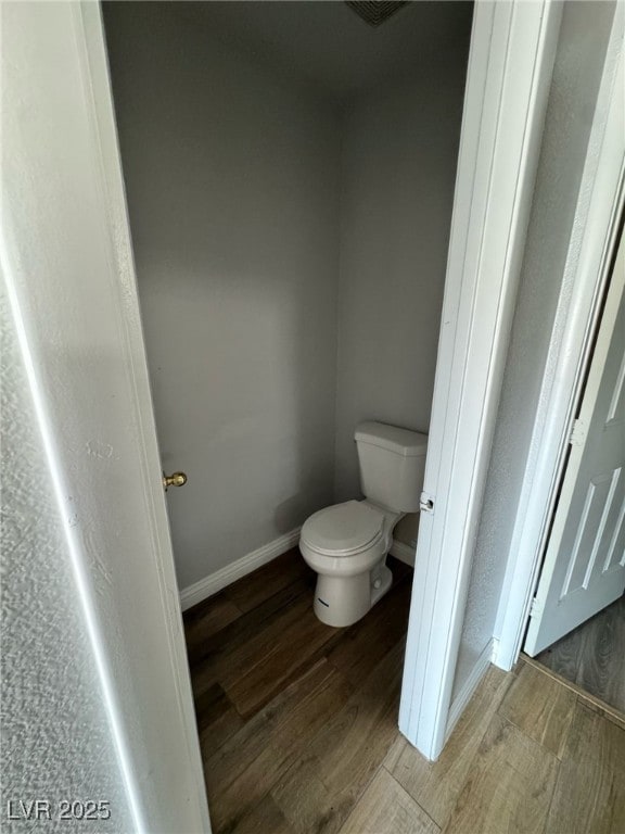 5711 Roundrock Dr, Las Vegas, NV 89142 - bathroom with toilet, baseboards, and wood finished floors