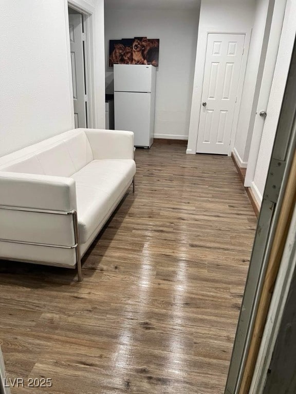5711 Roundrock Dr, Las Vegas, NV 89142 - sitting room with baseboards and dark wood-type flooring