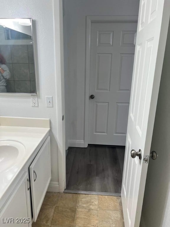 5711 Roundrock Dr, Las Vegas, NV 89142 - bathroom featuring vanity, baseboards, and wood finished floors