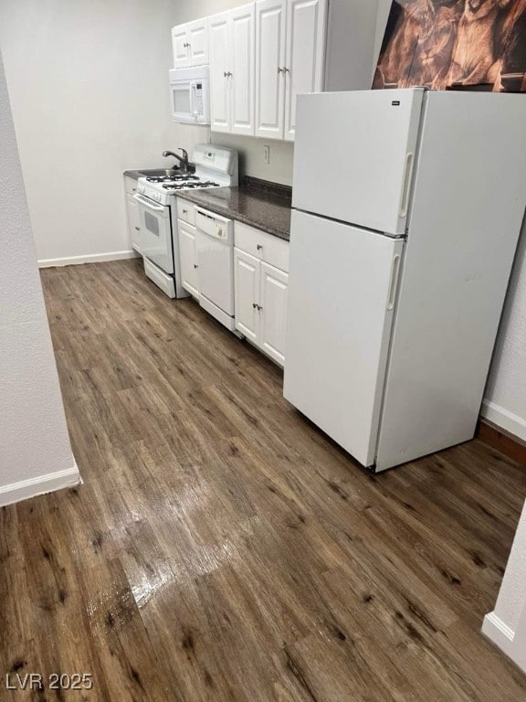5711 Roundrock Dr, Las Vegas, NV 89142 - kitchen featuring white appliances, dark wood-style flooring, dark countertops, and white cabinetry
