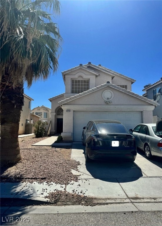 5711 Roundrock Dr, Las Vegas, NV 89142 - view of front of home featuring an attached garage, stucco siding, and driveway