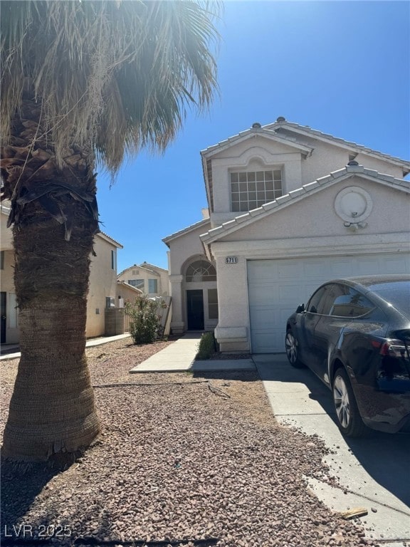 5711 Roundrock Dr, Las Vegas, NV 89142 - view of front facade with an attached garage, stucco siding, and driveway