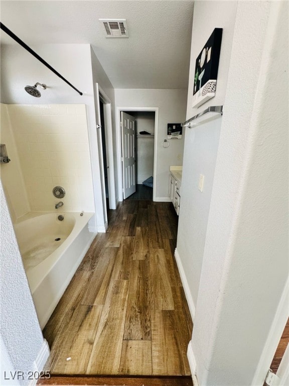 5711 Roundrock Dr, Las Vegas, NV 89142 - bathroom with shower / bath combination, baseboards, wood finished floors, and visible vents