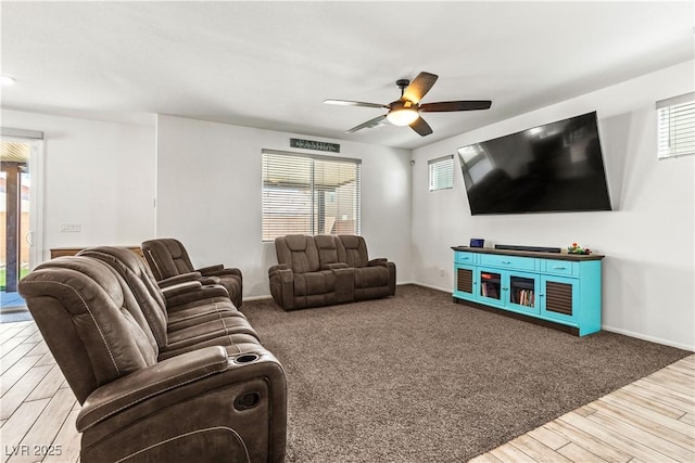 living area featuring ceiling fan, wood finished floors, and baseboards