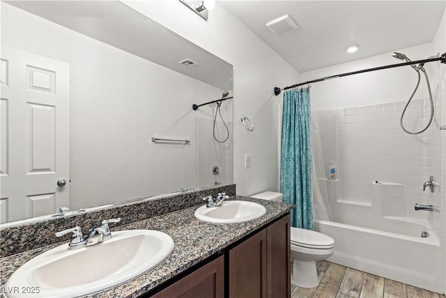 bathroom with shower / tub combo, wood finished floors, toilet, and double vanity
