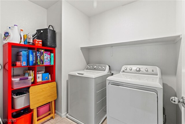 laundry room featuring washer and dryer and light tile patterned floors