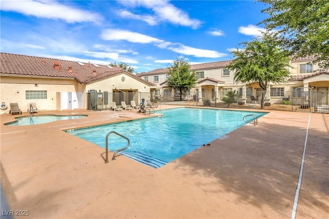 community pool featuring a patio area and fence