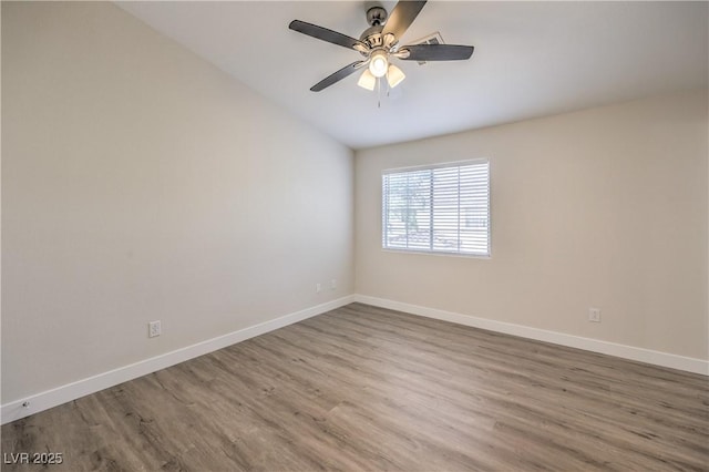 unfurnished room featuring baseboards, ceiling fan, and wood finished floors