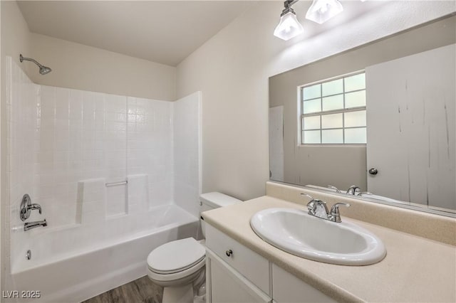 bathroom with shower / bath combination, vanity, toilet, and wood finished floors