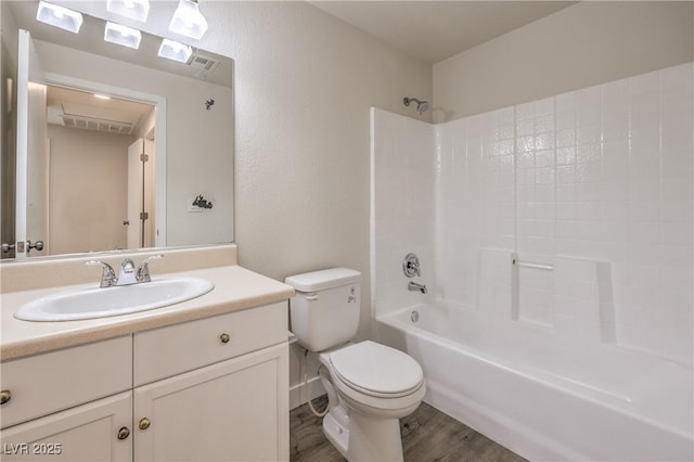 full bathroom featuring toilet,  shower combination, wood finished floors, and vanity