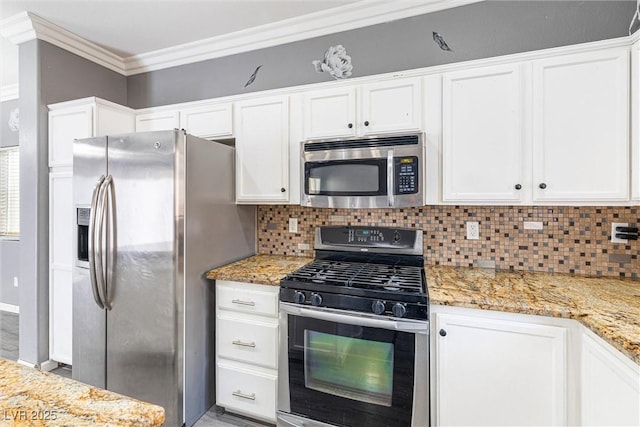 kitchen featuring crown molding, decorative backsplash, white cabinets, light stone counters, and appliances with stainless steel finishes