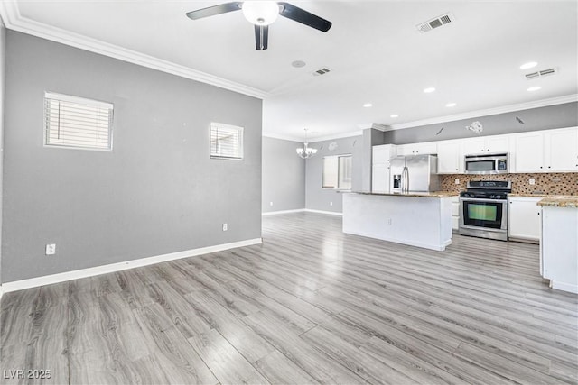 kitchen with crown molding, appliances with stainless steel finishes, open floor plan, and visible vents