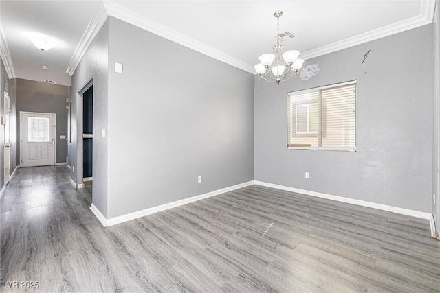 unfurnished room with crown molding, baseboards, a chandelier, and visible vents