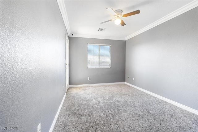 carpeted spare room with visible vents, ornamental molding, baseboards, and ceiling fan