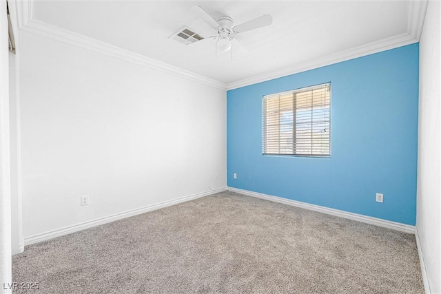 empty room featuring ceiling fan, visible vents, baseboards, ornamental molding, and carpet