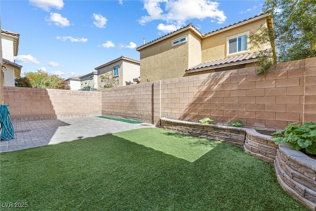 view of yard with a fenced backyard and a patio area