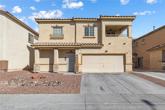 view of front of house with a garage, stucco siding, concrete driveway, and a tiled roof