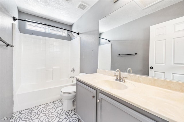 bathroom featuring vanity, visible vents, toilet, a textured ceiling, and shower / bathing tub combination