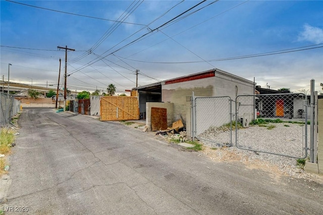 view of property exterior featuring fence and a gate